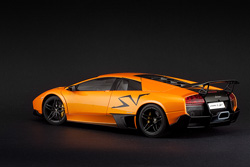 Bright cars like this orange metallic one are perfect on a black paper background